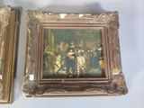 two framed paintings of a painting of a group of people on a wall