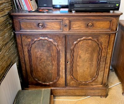a television on top of a wooden cabinet in a room