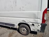 a white van that has been vandalized and is parked in a lot