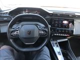 someone is sitting in the driver ' s seat of a car with their feet on the steering wheel