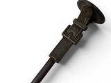 a metal pipe with a handle on a white surface