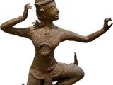 bronze statue of a woman with a bird on her head
