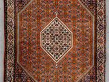 an antique persian rug with a geometric design