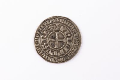 a close up of a coin on a white surface with a white background