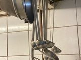 pots and pans hanging from the ceiling in a kitchen