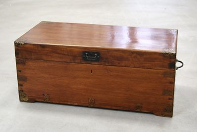 a wooden chest with a metal latch on it