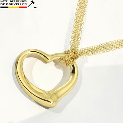 un pendentif en or en forme de cœur, monté sur une chaîne en or
