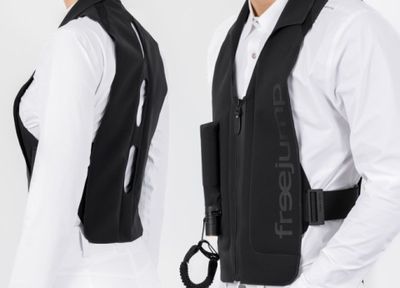 two men in white shirts and black vests posing for a picture