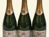three bottles of champagne sitting next to each other on a table