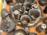 a box full of old silver dishes and pans
