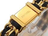 an image of a gold and black bracelet with a square clasp