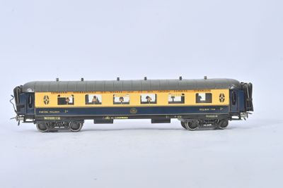 a blue and yellow train car with people on it