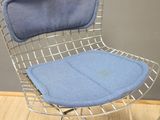 a chair with a blue cushion on it on a wooden floor