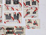 several pieces of paper taped to a white board with red and black lines