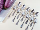 a plate with spoons and spoons next to an eggplant