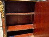 a wooden cabinet with a door open on the floor