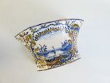 a blue and white bowl with a picture of a boat on it
