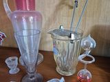 a lot of glass items sitting on a wooden table