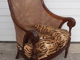 an image of a chair with a tiger print cushion on it