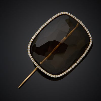 a black diamond and gold broochet broochle