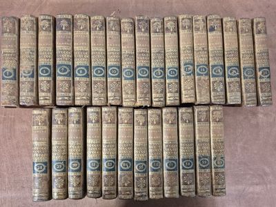 several old books stacked on top of each other on a table