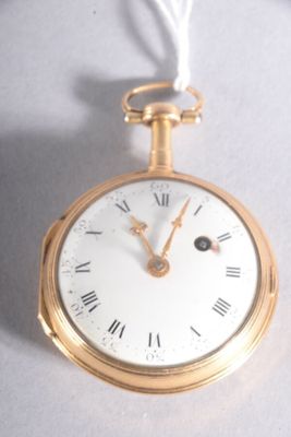 a gold pocket watch with roman numerals on it