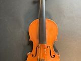 a violin hanging on the wall next to the wall