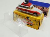 a red and white toy car sitting on top of a box