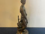 bronze figurine of a woman holding a basket of flowers