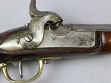 an old gun with a wooden handle on a white surface