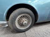 a close up of a car with a tire on the street