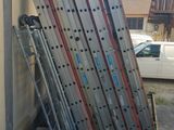 a stack of ladders leaning against a building