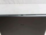 the back of a laptop computer sitting on top of a white table