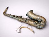 a saxophone that is sitting on a white surface