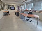a room with desks and chairs in it