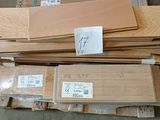 several pieces of wood are stacked on pallets in a warehouse