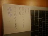 a note written on a piece of paper next to a computer keyboard