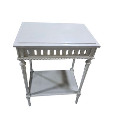 a white table with a shelf underneath it
