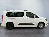 the white van is parked on the concrete floor in the room