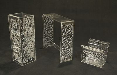 three clear vases sitting next to each other on a black background