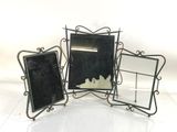 three mirrors that are sitting next to each other on a table