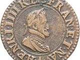Gros plan sur une pièce de monnaie représentant un homme.