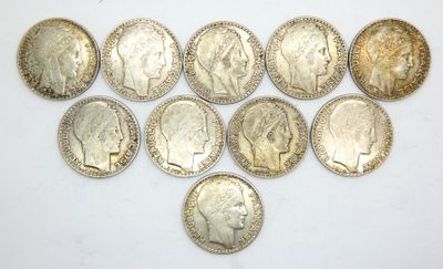 a bunch of silver coins sitting on top of a white surface