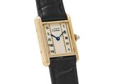 an image of a gold and black watch with roman numerals