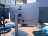 two computer monitors and a keyboard on a desk
