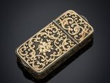 a gold - plated cigarette case with a floral design