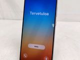 a close up of a cell phone on a stand on a table