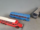 three toy buses that are sitting next to each other