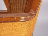 a close up of a wooden chair with a brown seat