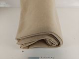 a roll of tan fabric next to a small card